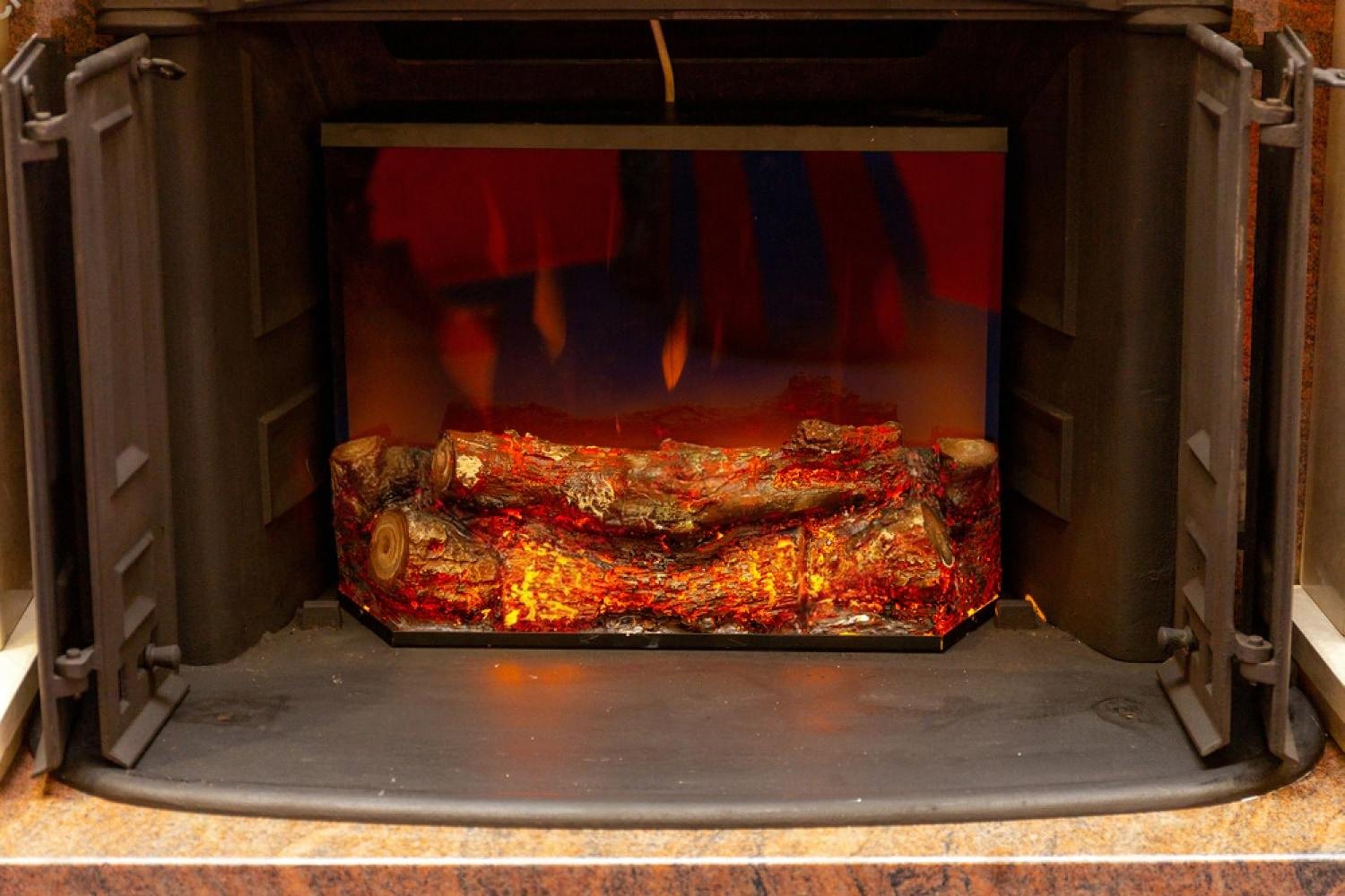 Decorative fireplace warming a covered terrace for an outdoor event in the UAE